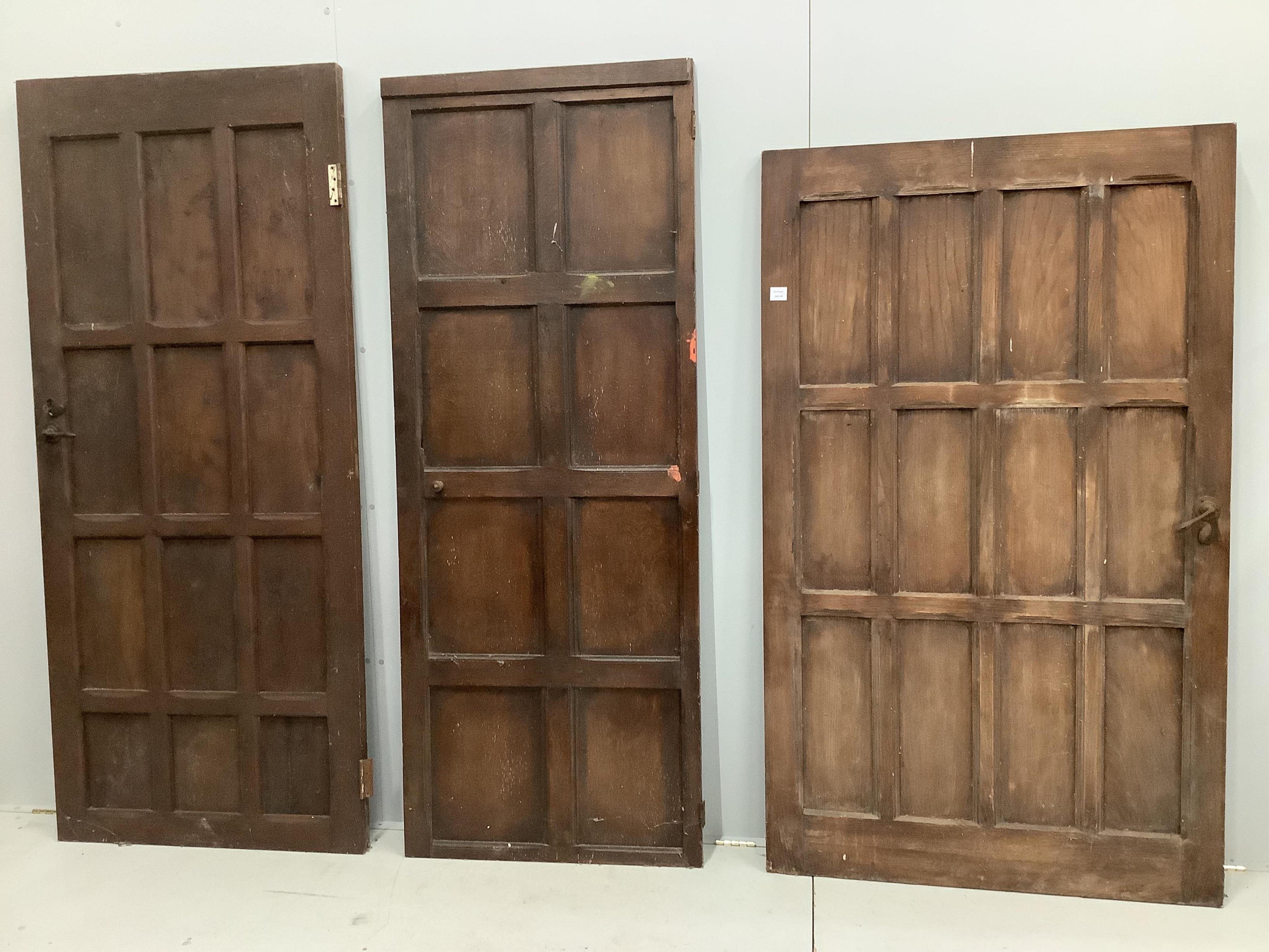 Three various panelled oak doors, largest width 107cm, height 181cm. Condition - poor to fair